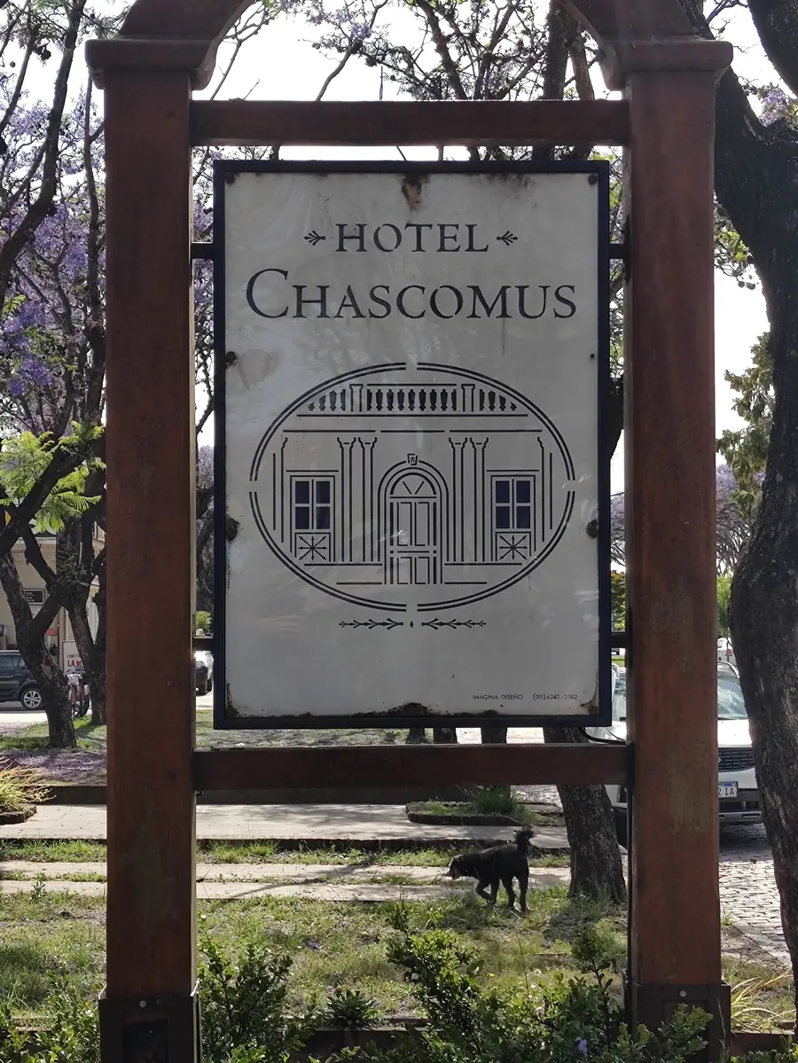 El cartel de madera del hotel, con el escudo de la fachada.