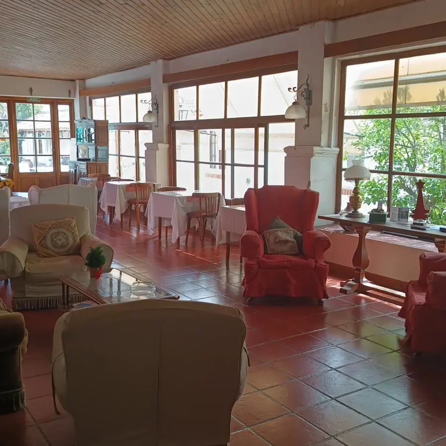 El lobby, luminoso, con los sillones rojos.
