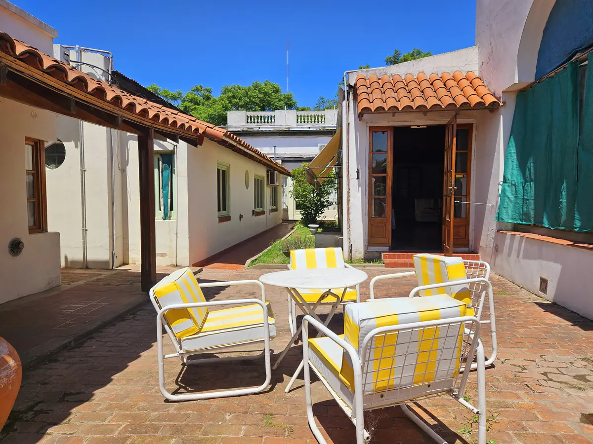 La galería con las mesas al sol.